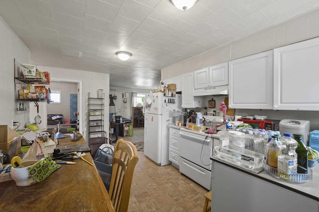420 E Sanson Ave, Spokane, WA 99207 - kitchen with white appliances, under cabinet range hood, white cabinetry, and light flooring
