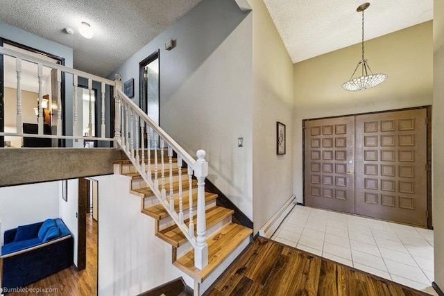 10511 E Cimmaron Dr, Spokane, WA 99206 - foyer with stairway, wood finished floors, a textured ceiling, and baseboards