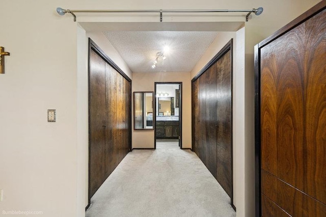 10511 E Cimmaron Dr, Spokane, WA 99206 - hallway with light colored carpet and a textured ceiling