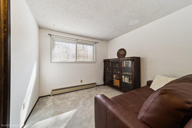 10511 E Cimmaron Dr, Spokane, WA 99206 - sitting room with a baseboard heating unit, light carpet, and a textured ceiling