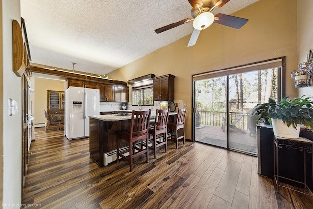 10511 E Cimmaron Dr, Spokane, WA 99206 - kitchen featuring white fridge with ice dispenser, a textured ceiling, light countertops, dark wood-style floors, and dark brown cabinets