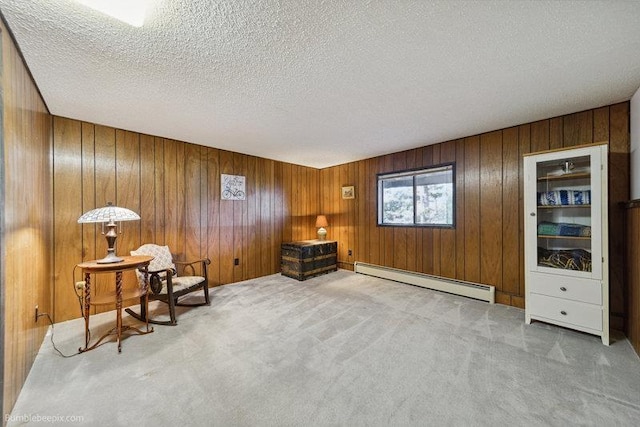 10511 E Cimmaron Dr, Spokane, WA 99206 - living area featuring baseboard heating, carpet flooring, a textured ceiling, and wood walls