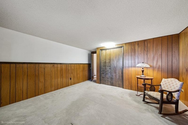 10511 E Cimmaron Dr, Spokane, WA 99206 - sitting room featuring carpet, wooden walls, and a textured ceiling