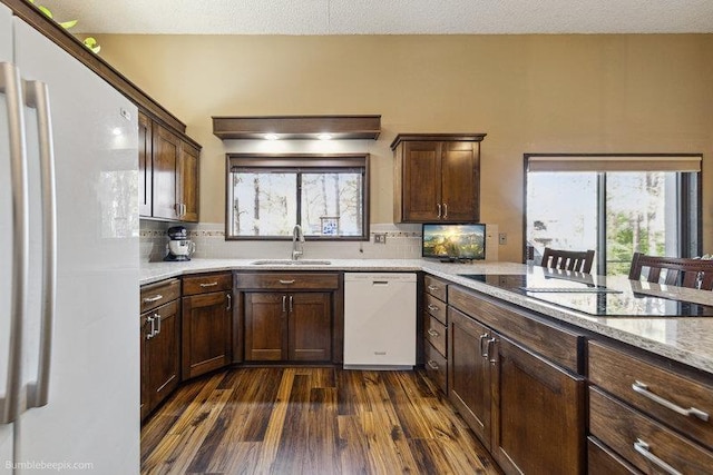 10511 E Cimmaron Dr, Spokane, WA 99206 - kitchen with white appliances, a sink, dark wood-style floors, and plenty of natural light
