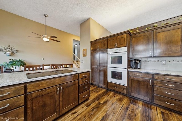 10511 E Cimmaron Dr, Spokane, WA 99206 - kitchen featuring white double oven, black electric stovetop, a textured ceiling, dark wood-type flooring, and backsplash