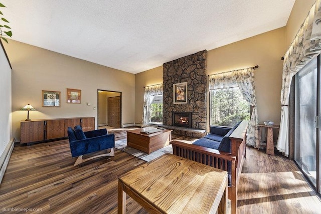 10511 E Cimmaron Dr, Spokane, WA 99206 - living area with a fireplace, wood finished floors, vaulted ceiling, and a textured ceiling