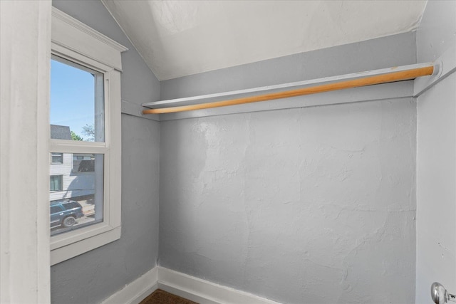 walk in closet with vaulted ceiling