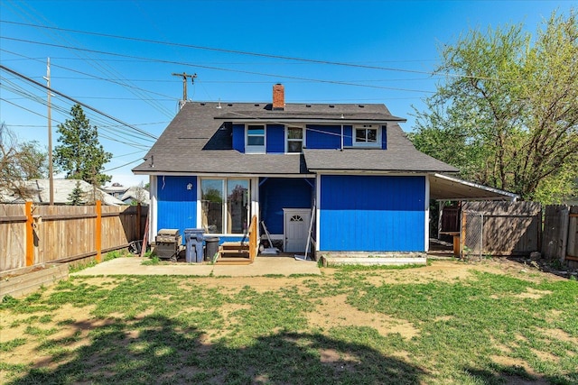 rear view of house featuring a chimney, entry steps, and a shingled roof