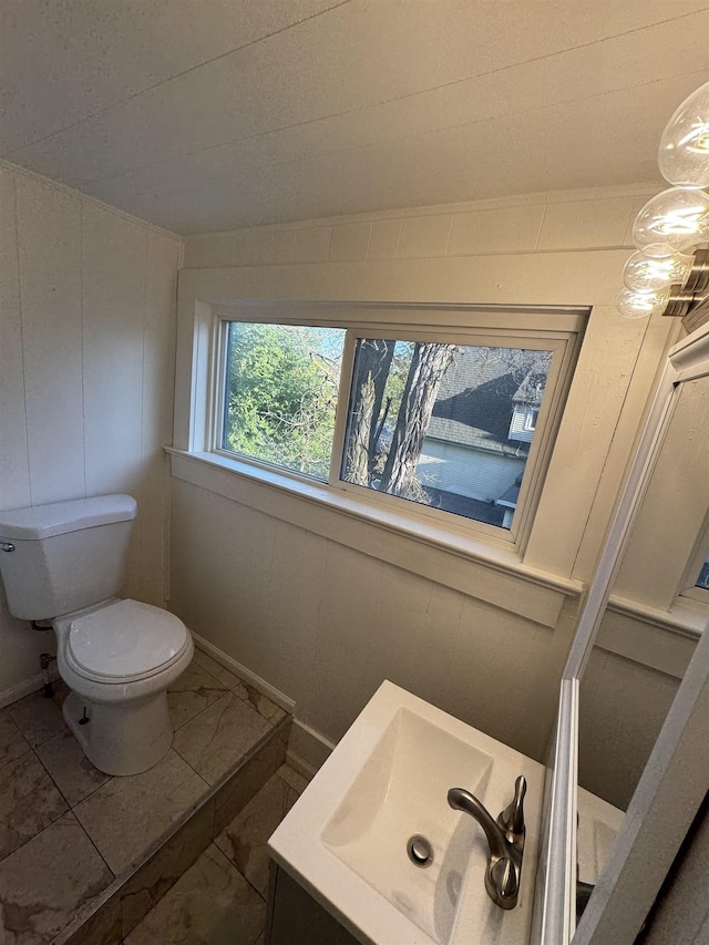 2209 N Washington St, Spokane, WA 99205 - bathroom with marble finish floors, toilet, vanity, and baseboards