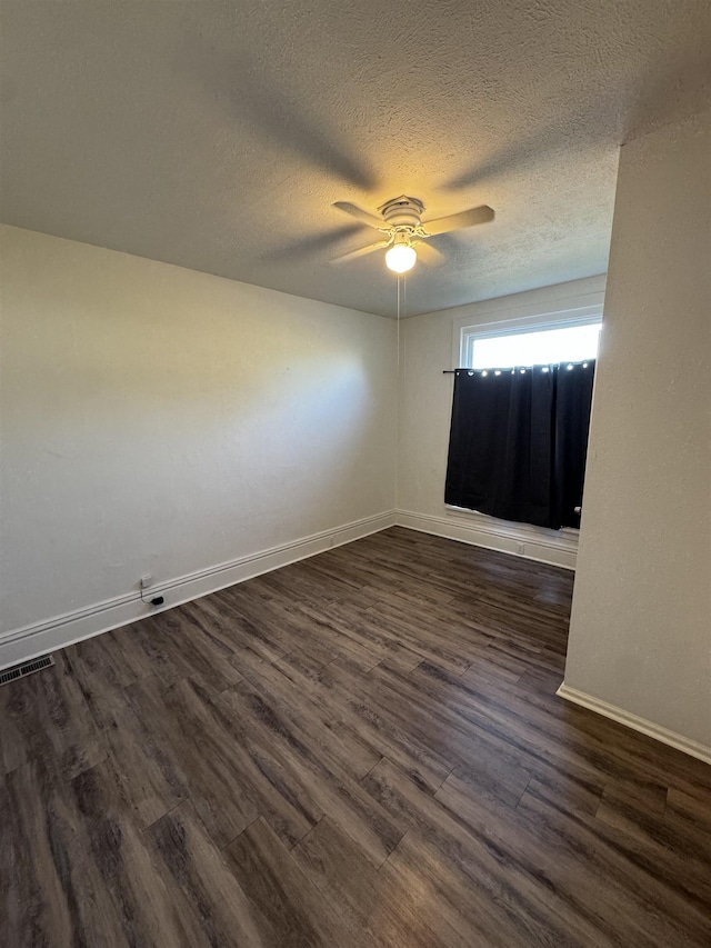 2209 N Washington St, Spokane, WA 99205 - unfurnished room featuring dark wood-type flooring, a ceiling fan, baseboards, and a textured ceiling