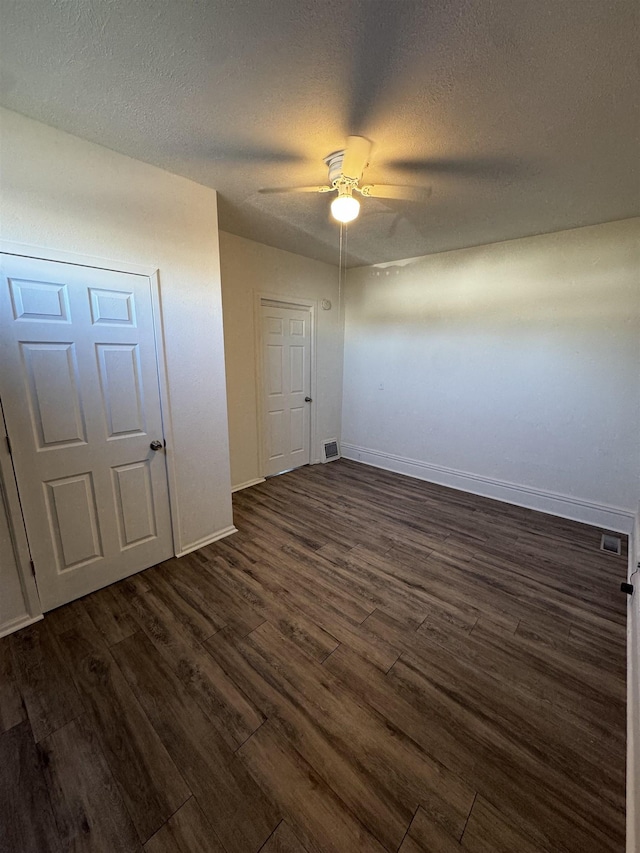 2209 N Washington St, Spokane, WA 99205 - unfurnished bedroom featuring dark wood finished floors, baseboards, a textured ceiling, and ceiling fan