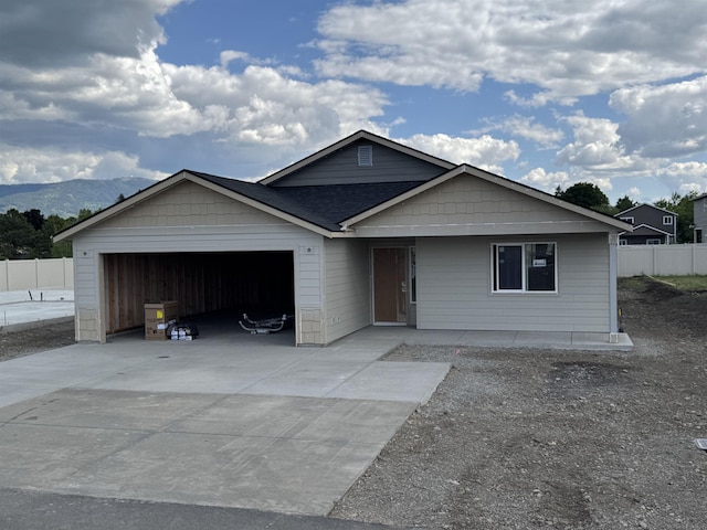 18420 E 1st Ln, Spokane Valley, WA 99016 - view of front of home with an attached garage, driveway, a mountain view, and roof with shingles