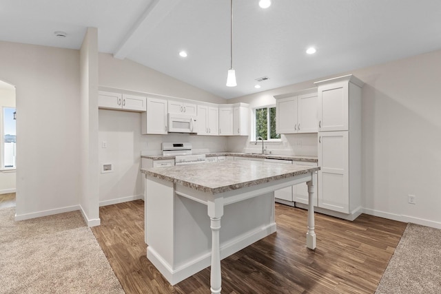18420 E 1st Ln, Spokane Valley, WA 99016 - kitchen with white microwave, range, light countertops, a center island, and white cabinetry
