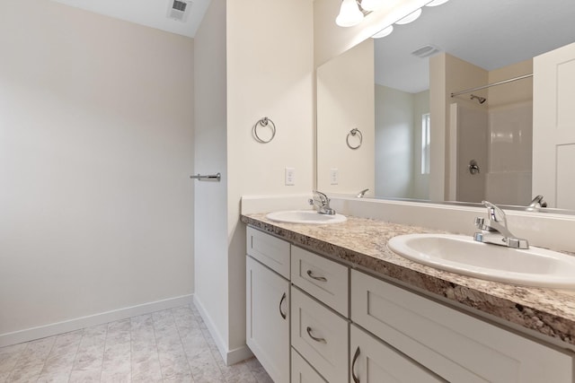 18420 E 1st Ln, Spokane Valley, WA 99016 - bathroom with double vanity, baseboards, and a shower