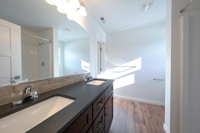 18420 E 1st Ln, Spokane Valley, WA 99016 - full bathroom with wood finished floors, a shower, double vanity, and baseboards