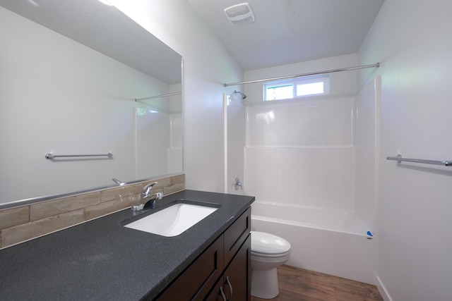 18420 E 1st Ln, Spokane Valley, WA 99016 - bathroom featuring vanity, toilet, bathing tub / shower combination, and wood finished floors