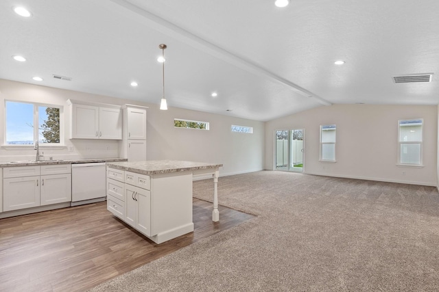 18420 E 1st Ln, Spokane Valley, WA 99016 - kitchen with white dishwasher, a sink, a breakfast bar, plenty of natural light, and vaulted ceiling