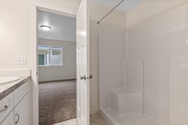18420 E 1st Ln, Spokane Valley, WA 99016 - bathroom with a shower, vanity, and baseboards