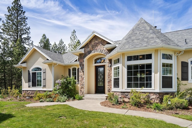 21718 W Watt Rd, Cheney, WA 99004 - view of front facade featuring stone siding, a front lawn, stucco siding, and roof with shingles