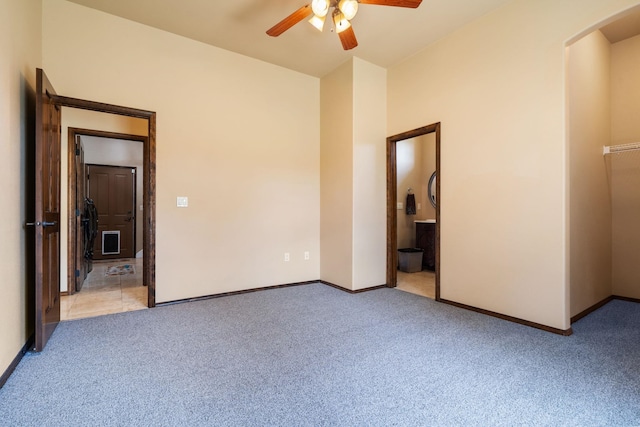 21718 W Watt Rd, Cheney, WA 99004 - unfurnished bedroom featuring light carpet, baseboards, arched walkways, and connected bathroom