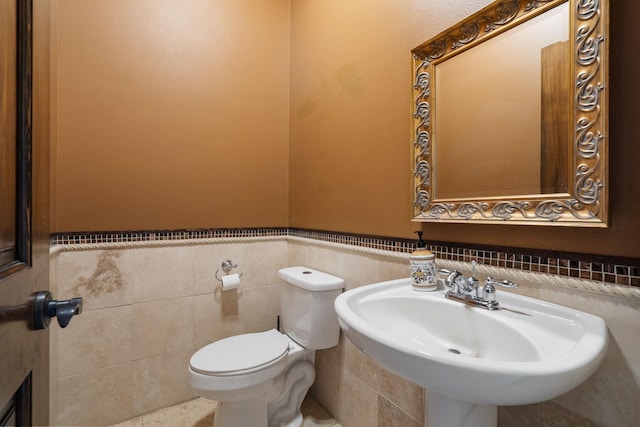 21718 W Watt Rd, Cheney, WA 99004 - half bathroom with toilet, wainscoting, tile walls, and a sink