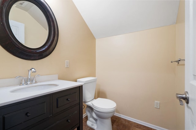 21718 W Watt Rd, Cheney, WA 99004 - half bath featuring toilet, vanity, vaulted ceiling, tile patterned flooring, and baseboards