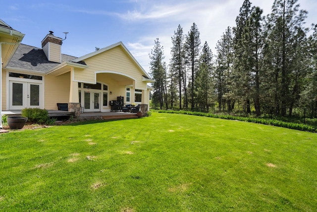 21718 W Watt Rd, Cheney, WA 99004 - back of property with french doors, a chimney, and roof with shingles