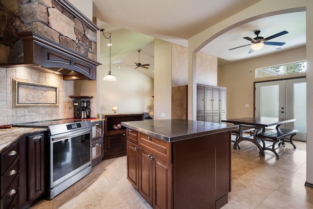 21718 W Watt Rd, Cheney, WA 99004 - kitchen with electric range, a ceiling fan, decorative backsplash, stainless steel counters, and lofted ceiling