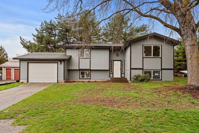 view of front of house featuring an attached garage, driveway, and a front lawn