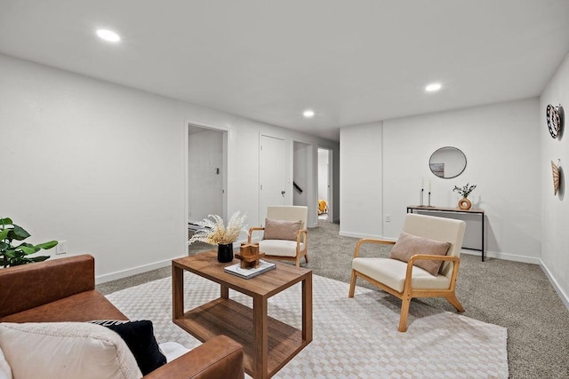 carpeted living area with recessed lighting and baseboards