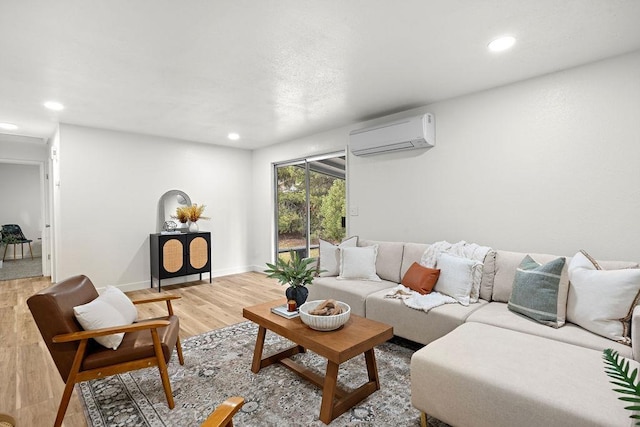 living area with a wall mounted air conditioner, light wood-style floors, recessed lighting, and baseboards