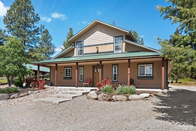 farmhouse with covered porch and metal roof