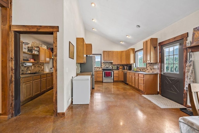 kitchen with appliances with stainless steel finishes, a sink, decorative backsplash, high vaulted ceiling, and baseboards