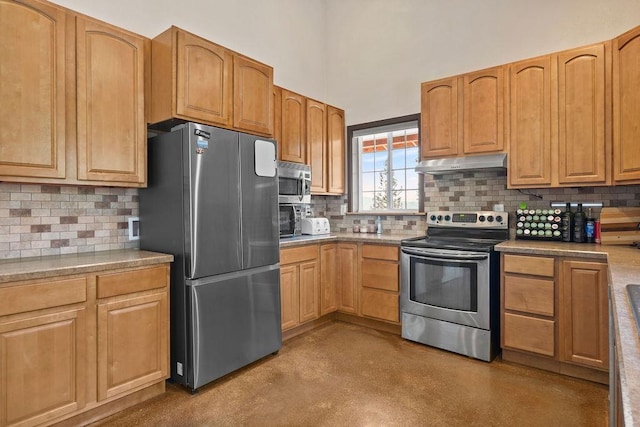 kitchen with appliances with stainless steel finishes, under cabinet range hood, concrete floors, decorative backsplash, and a towering ceiling