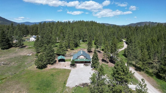 view from above of property featuring a heavily wooded area and mountains