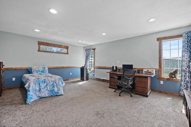 carpeted bedroom featuring radiator, recessed lighting, an office area, and baseboards