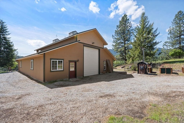 view of property exterior with a detached garage