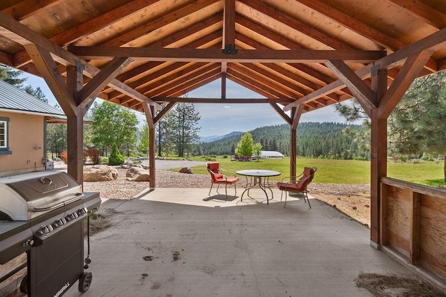 view of patio / terrace featuring a gazebo, a mountain view, and grilling area