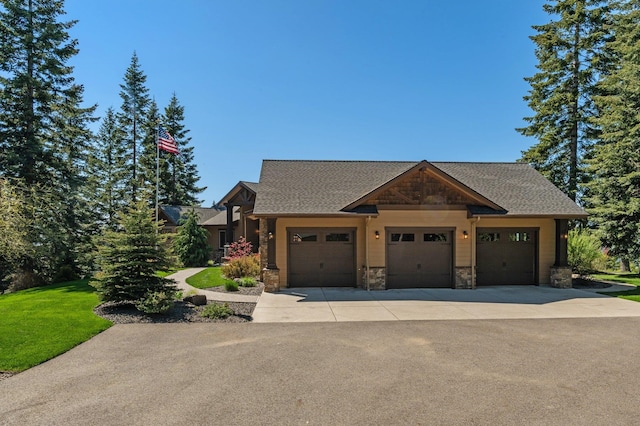 craftsman inspired home with stone siding, a garage, driveway, and a shingled roof