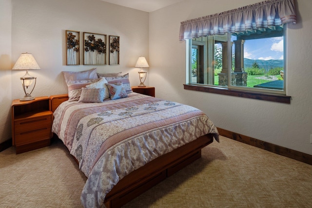 carpeted bedroom featuring baseboards