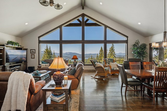 living room featuring a chandelier, a mountain view, dark wood-style flooring, and recessed lighting