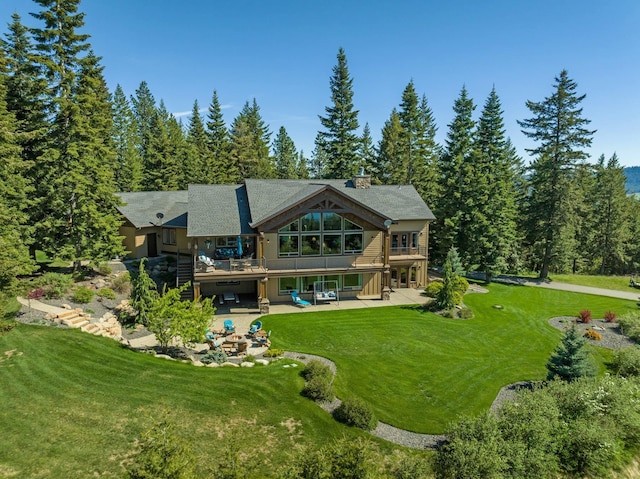 back of property featuring a patio, a yard, and a deck