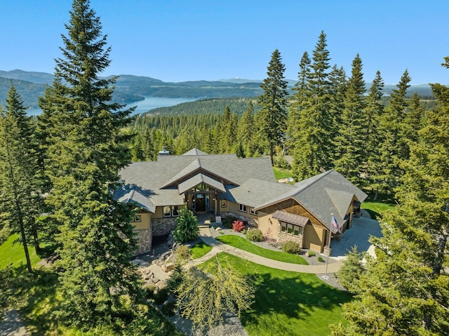 view of subject property with a heavily wooded area and a mountainous background