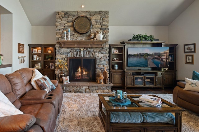 living room with a fireplace, wood finished floors, and lofted ceiling