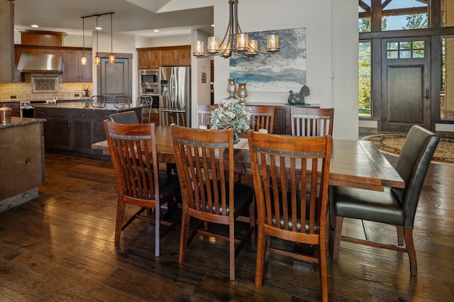 dining room with dark wood-style floors, a chandelier, and recessed lighting