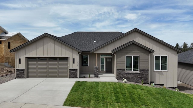 7025 E Beverly Ave, Spokane Valley, WA 99212 - view of front of home with stone siding, a shingled roof, concrete driveway, and a garage