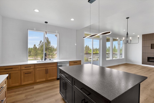 7025 E Beverly Ave, Spokane Valley, WA 99212 - kitchen featuring a sink, dishwasher, light wood-type flooring, a chandelier, and decorative light fixtures