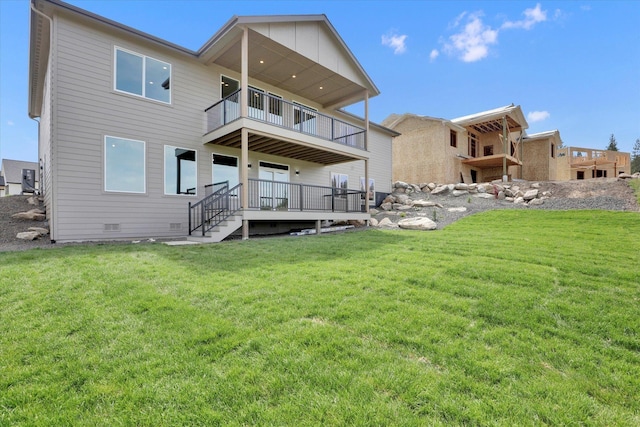 7025 E Beverly Ave, Spokane Valley, WA 99212 - back of property featuring a balcony, a lawn, crawl space, and board and batten siding