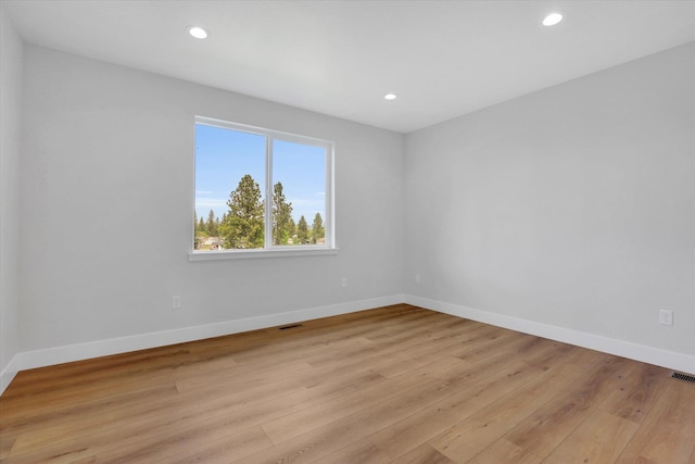 7025 E Beverly Ave, Spokane Valley, WA 99212 - empty room with light wood-style floors, baseboards, and recessed lighting
