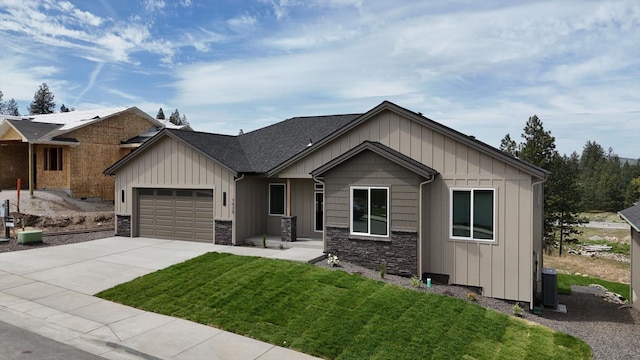 7025 E Beverly Ave, Spokane Valley, WA 99212 - view of front of house with an attached garage, driveway, a front lawn, and board and batten siding